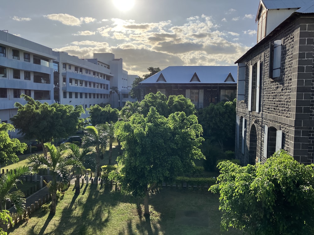 an aerial view of a building with trees in the foreground