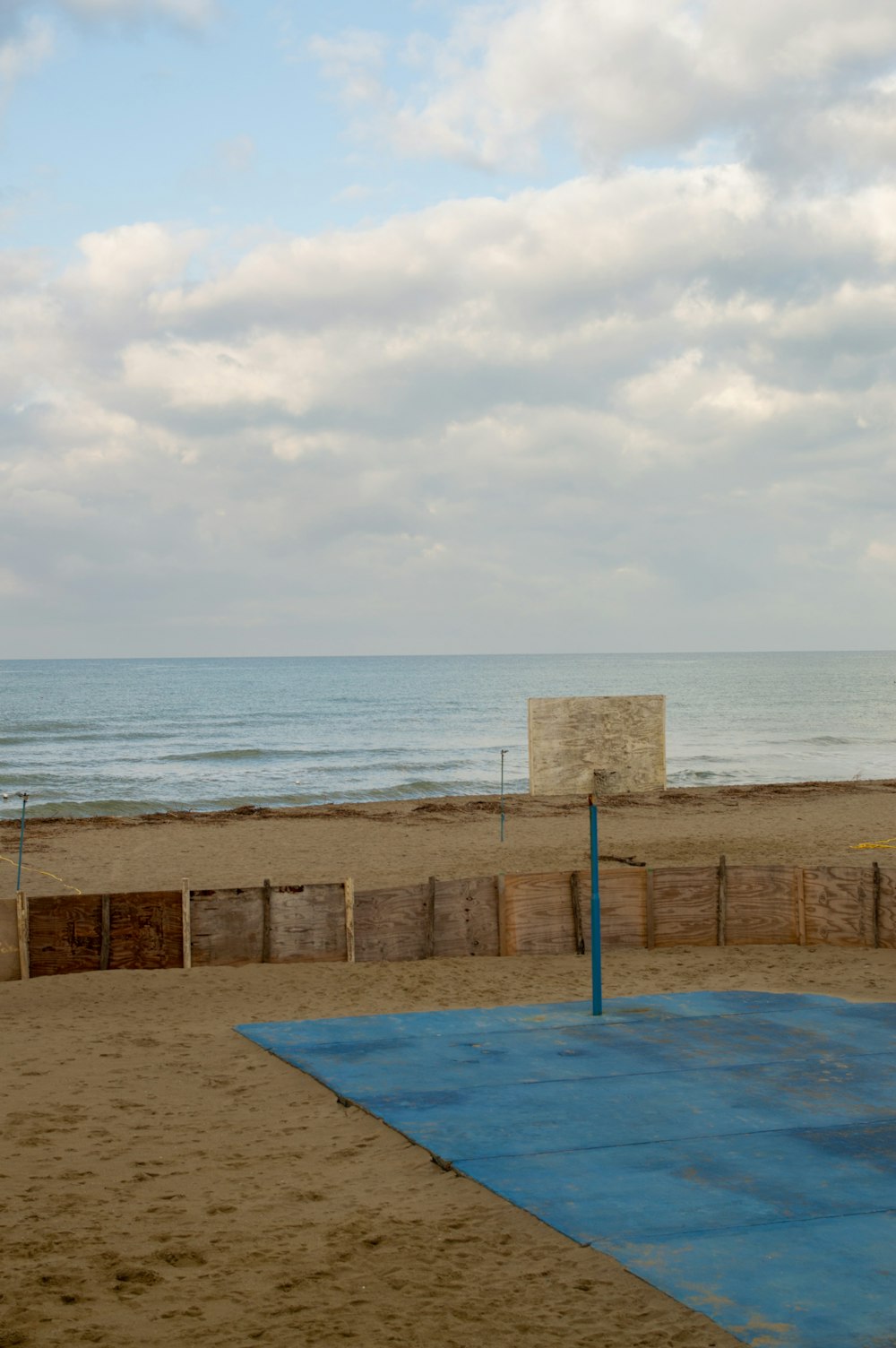 a basketball court on a beach near the ocean