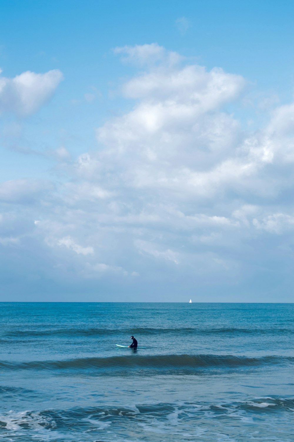 a man riding a wave on top of a surfboard