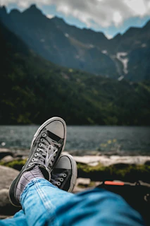 Casual canvas sneakers styled with denim and a sunny outdoor background