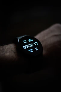 Modern smartwatch displaying fitness stats on a wrist against a dark background.