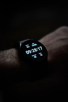 Modern smartwatch displaying fitness stats on a wrist against a dark background.