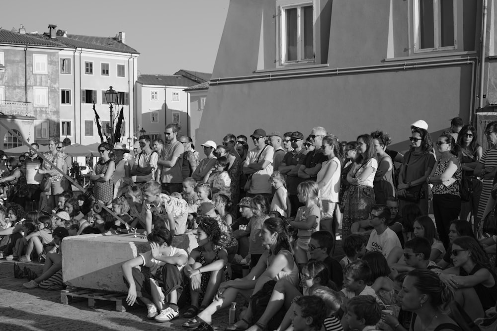 a crowd of people sitting on the side of a road