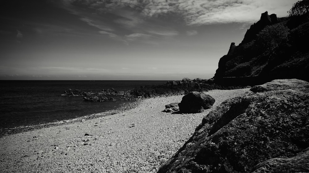 a black and white photo of a rocky beach