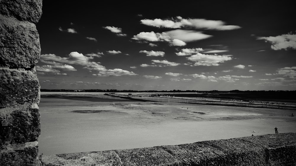 a black and white photo of a beach