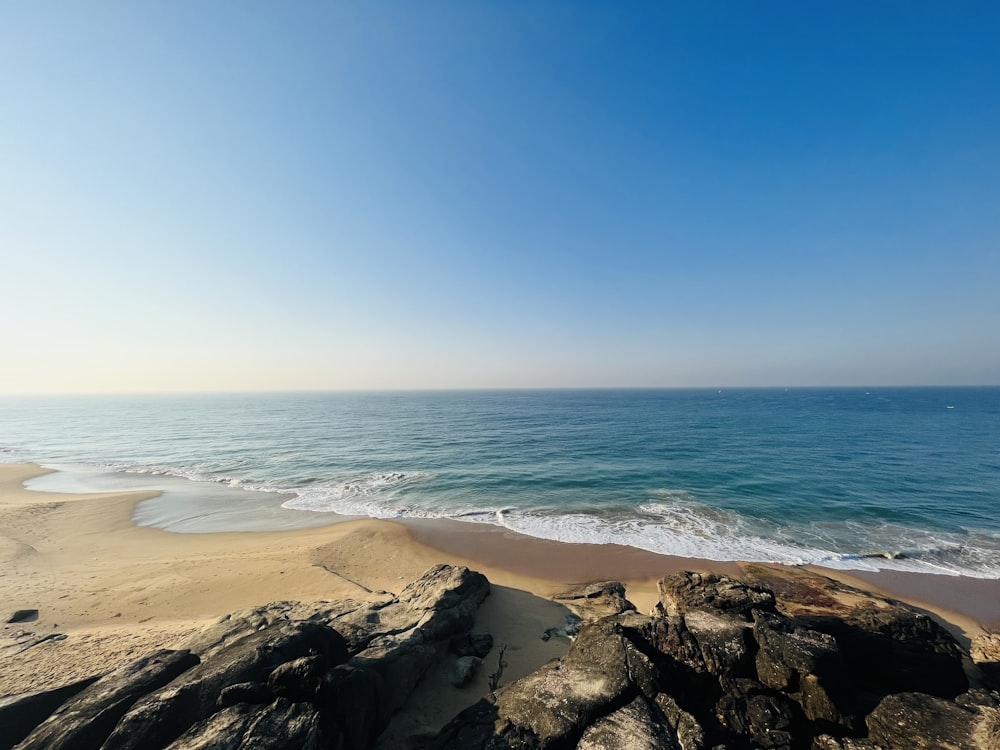 a view of the ocean from a rocky beach