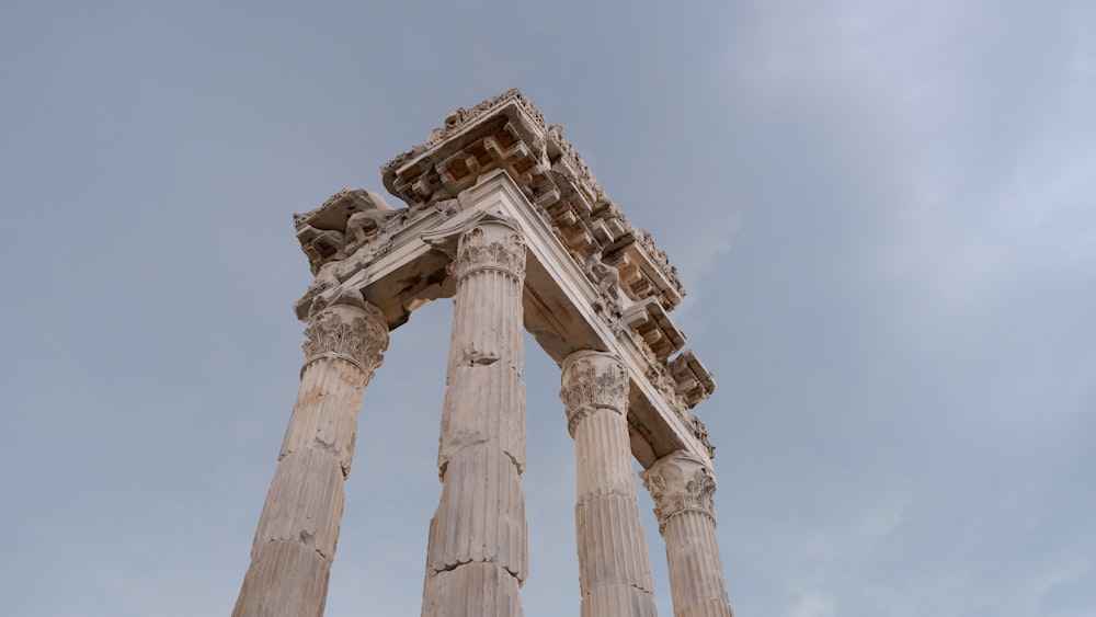 a tall white building with two columns on top of it