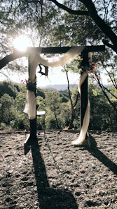 A beautifully decorated outdoor wedding garden with floral arches and ambient lighting at dusk.