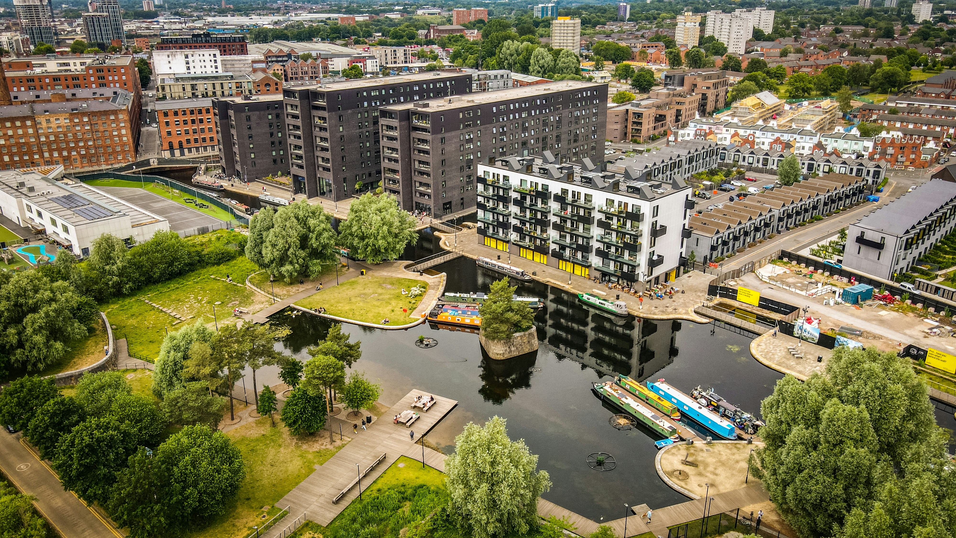 Dronw shot over New Islington Marina in Manchester, UK. One of only a few areas now with greenery in the city centre