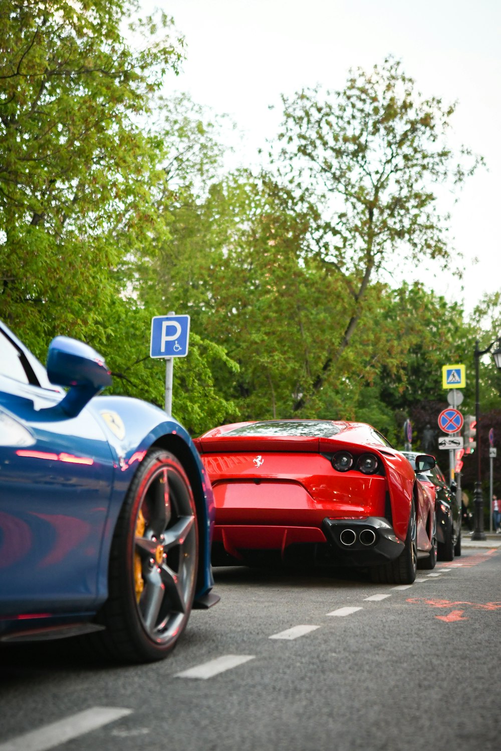 a couple of red sports cars parked next to each other