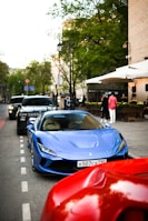 A sporty blue coupe parked outside a trendy Southern California cafe.