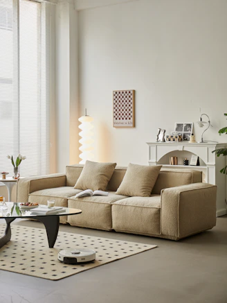 A sleek vacuum cleaner in action, capturing dust in a sunlit living room.