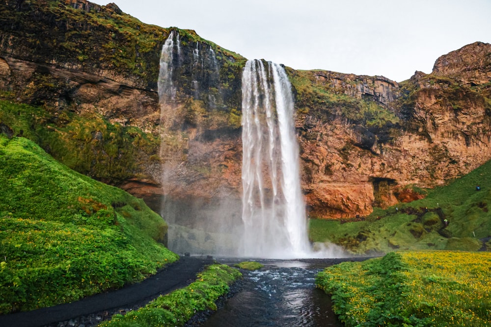 a waterfall with a river running under it