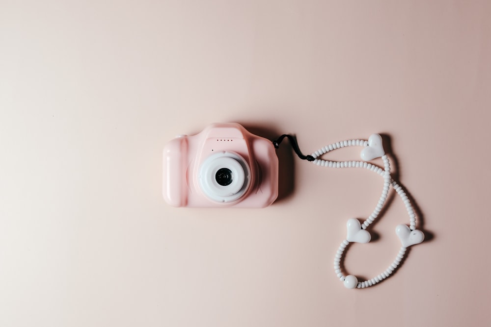 a pink camera sitting on top of a pink table