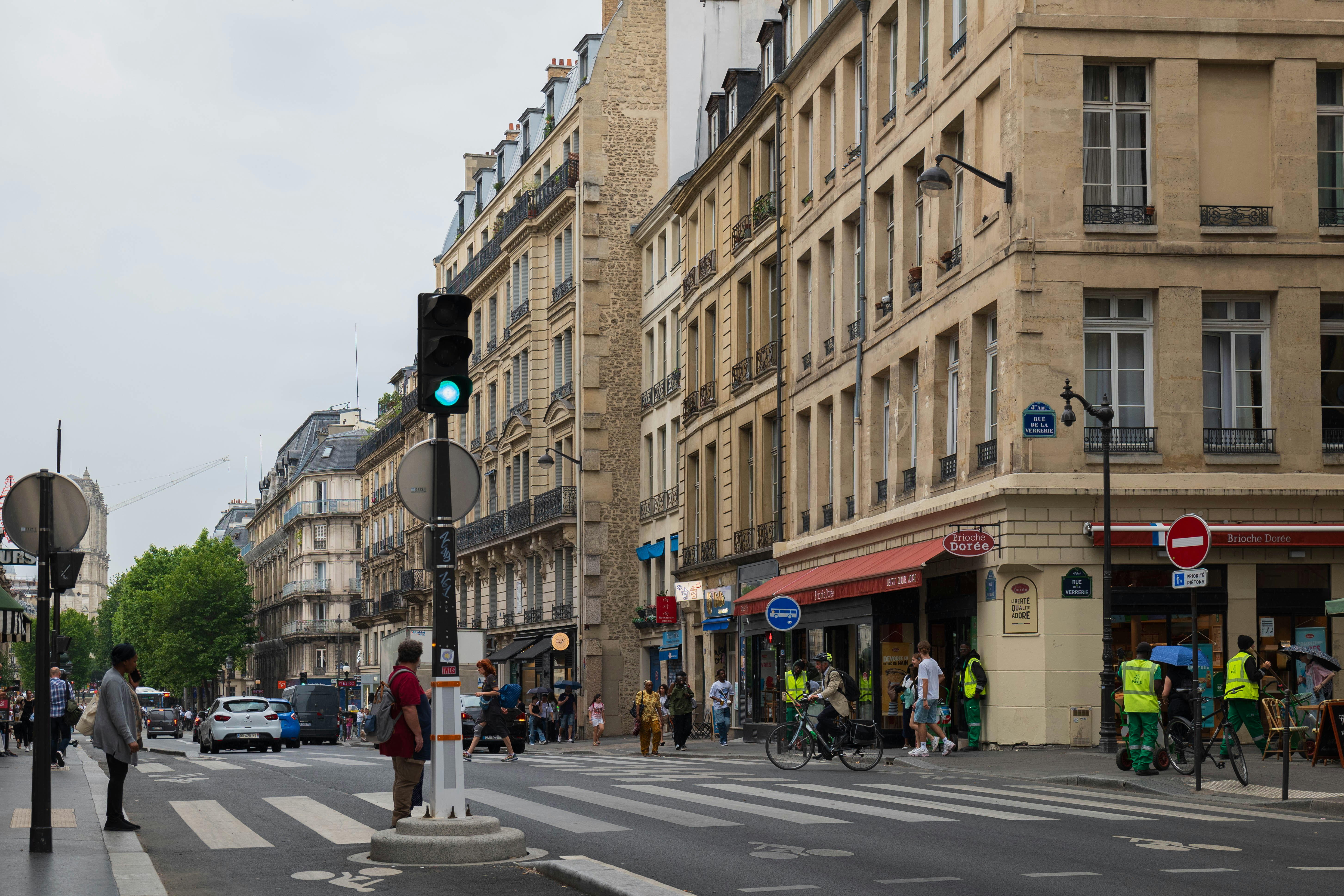 a busy city street with pedestrians and bicyclists
