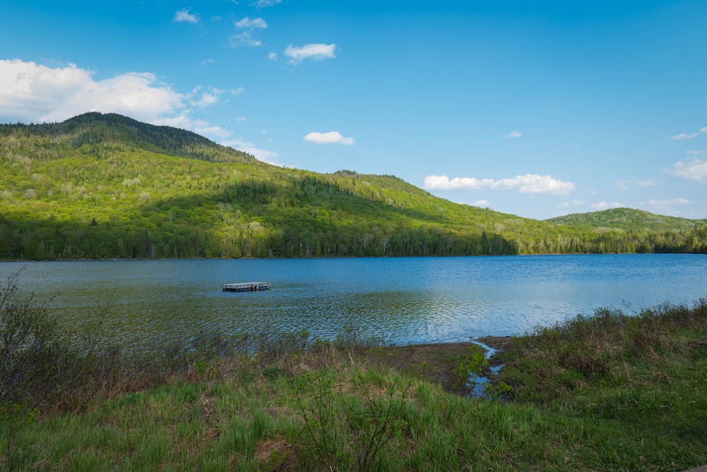 a small boat floating on top of a lake