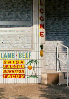 A welcoming storefront of a Mexican restaurant proudly displaying the Sabores Unidos membership plaque.