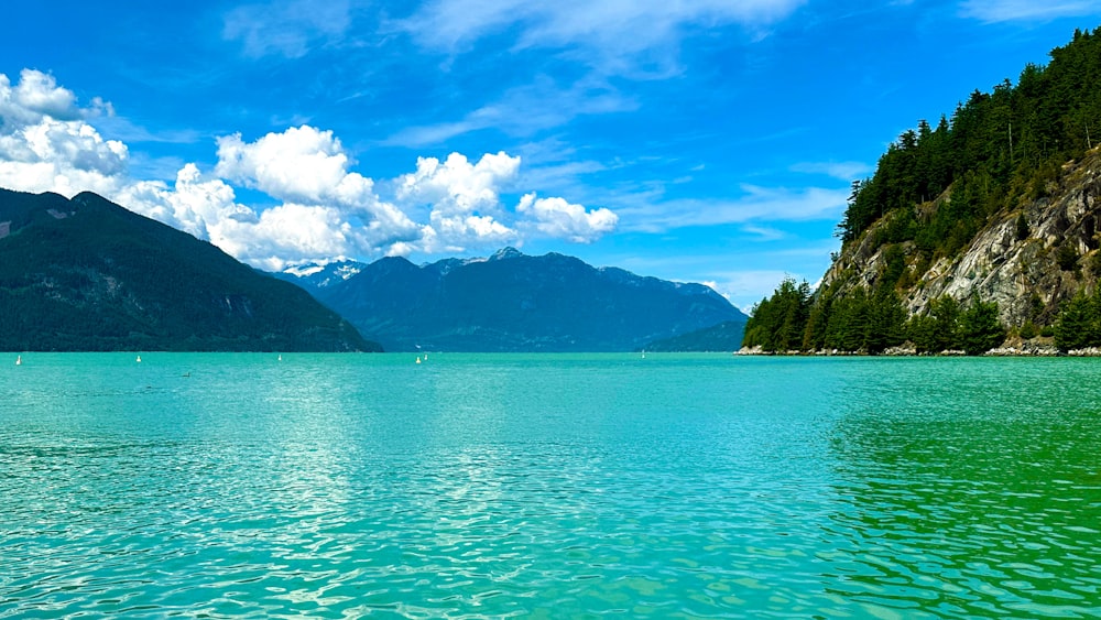 a large body of water with mountains in the background