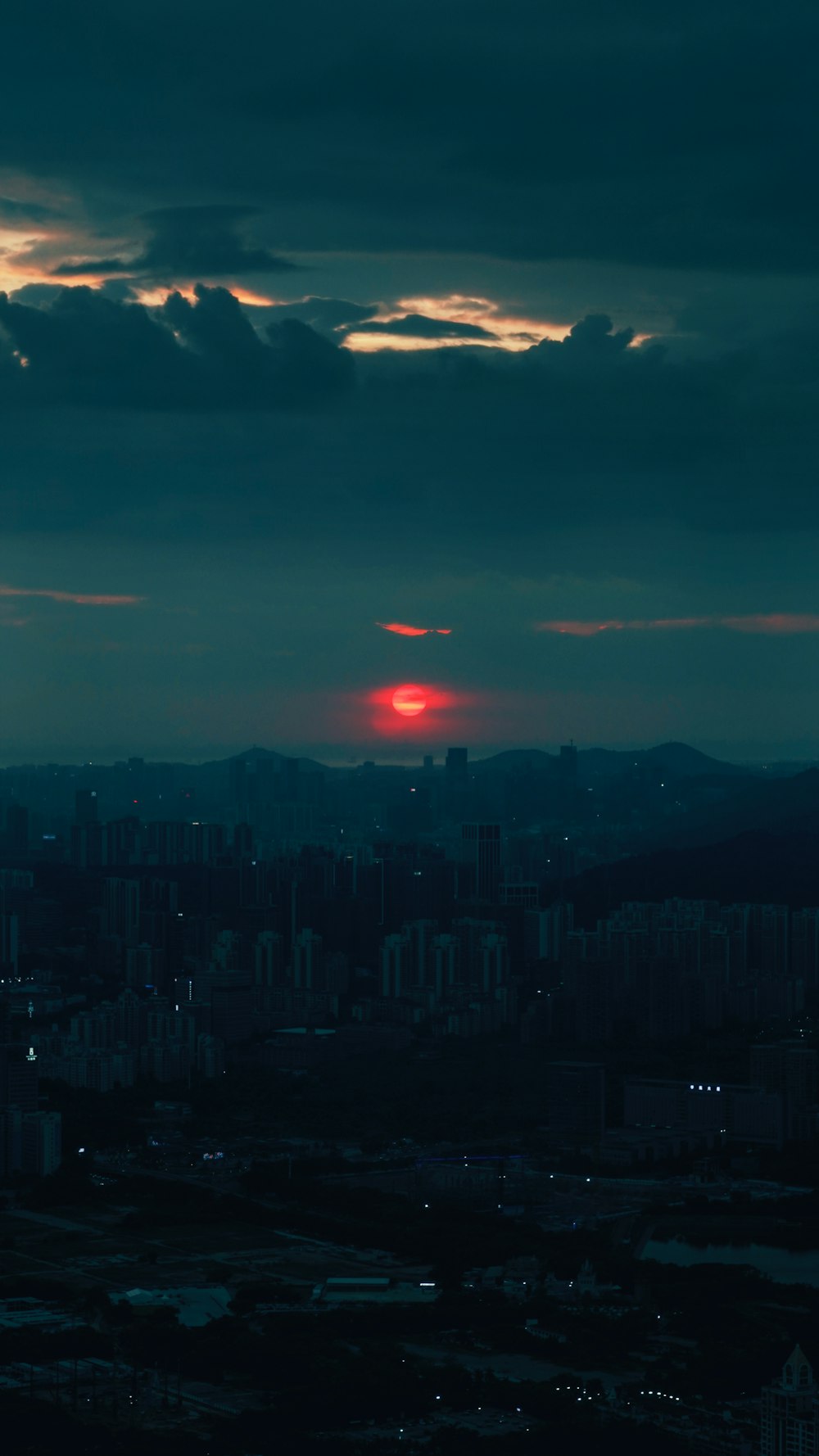 the sun is setting over a large city