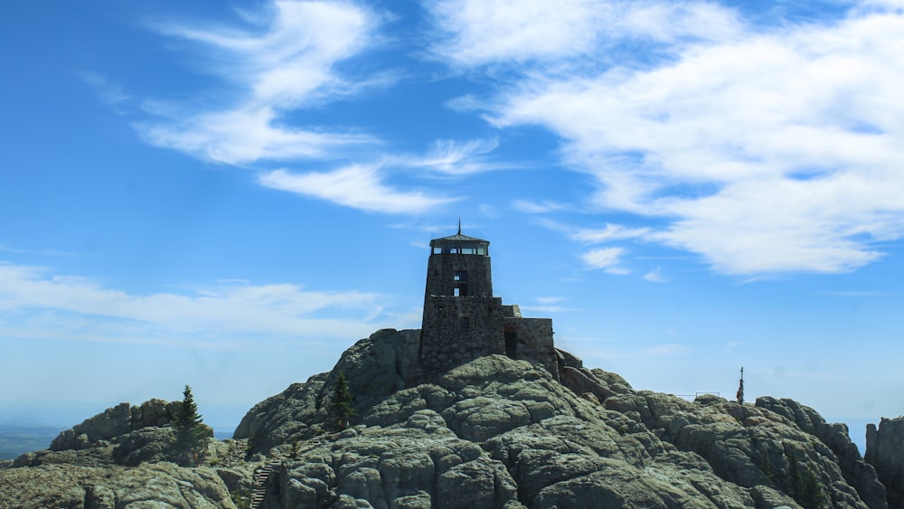 a tower on top of a mountain with a sky background