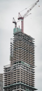 a tall building with a crane on top of it