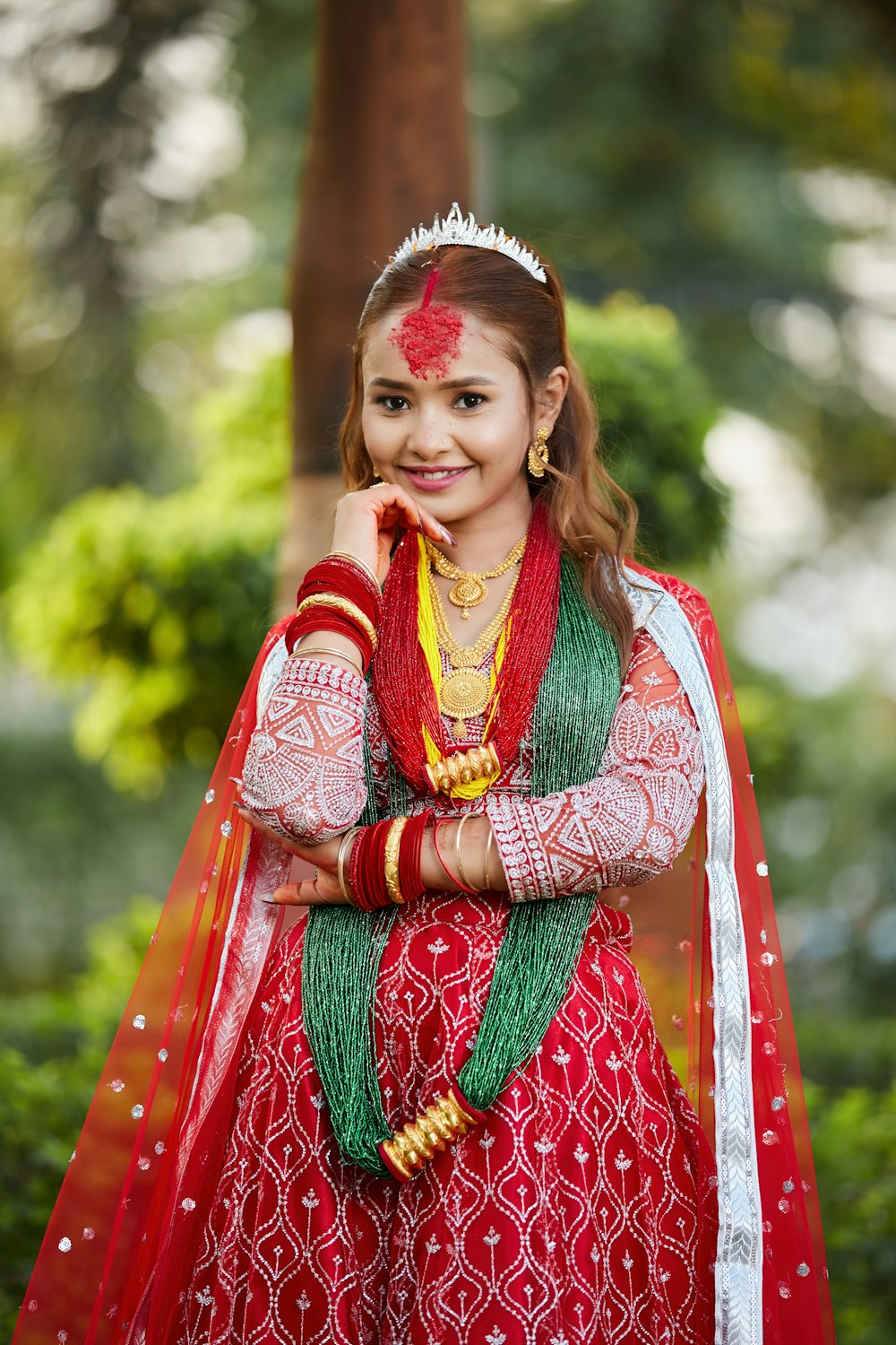 a young girl dressed in a red and green outfit