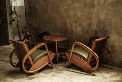 Stylish minimalist chairs arranged around a small table.