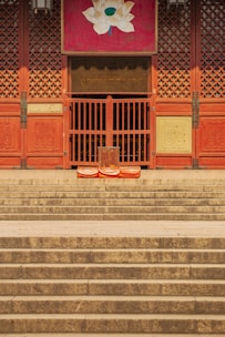 Compact lockable slipper stand positioned elegantly in a temple's shoe area.