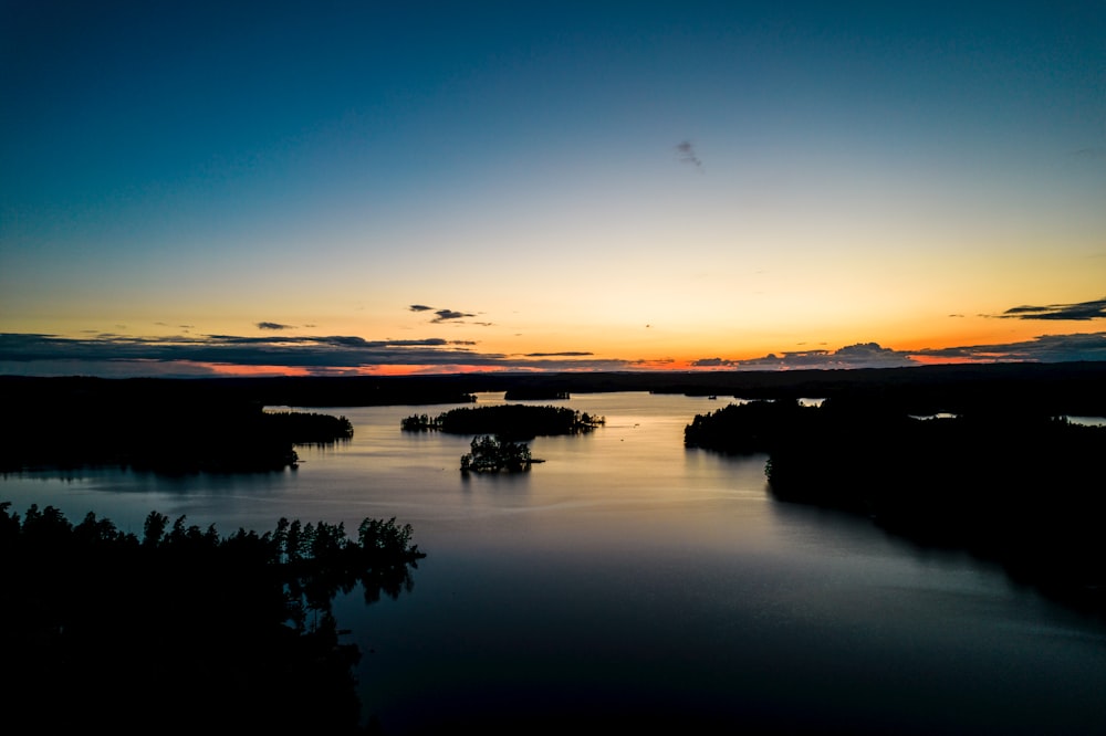 the sun is setting over a body of water