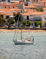 Participants practicing conversational sport techniques on a sailboat under clear blue skies near the Mediterranean coast.