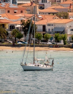 A family enjoying a rented sailboat anchored in a calm cove of Mallorca.