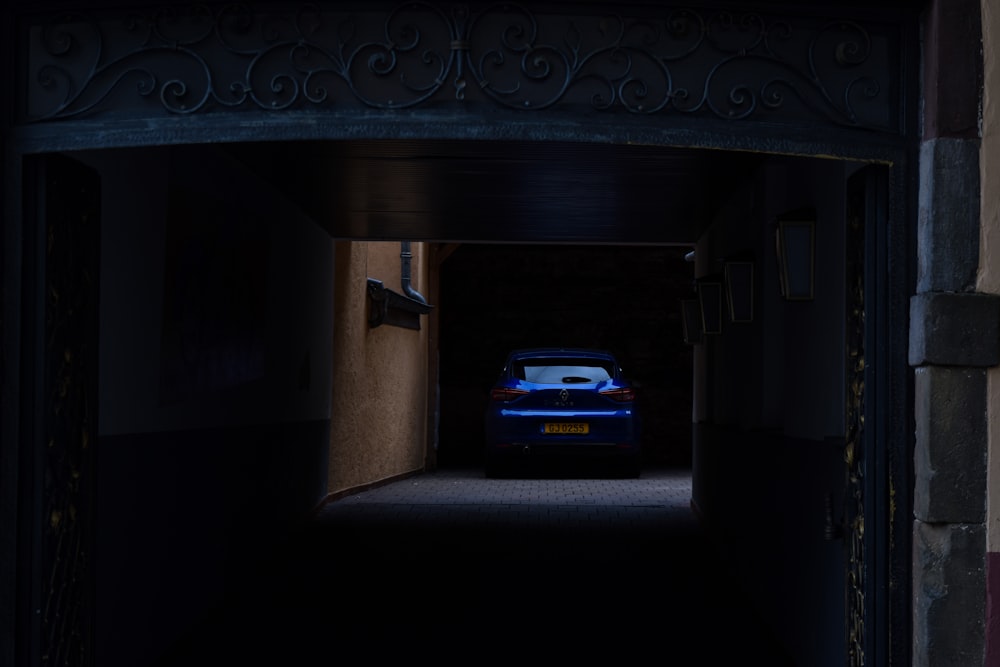 a car is parked in a dimly lit garage