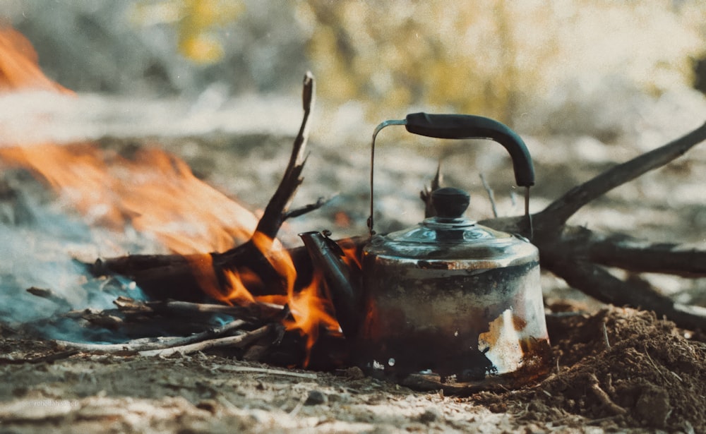 a tea kettle sitting on top of a fire