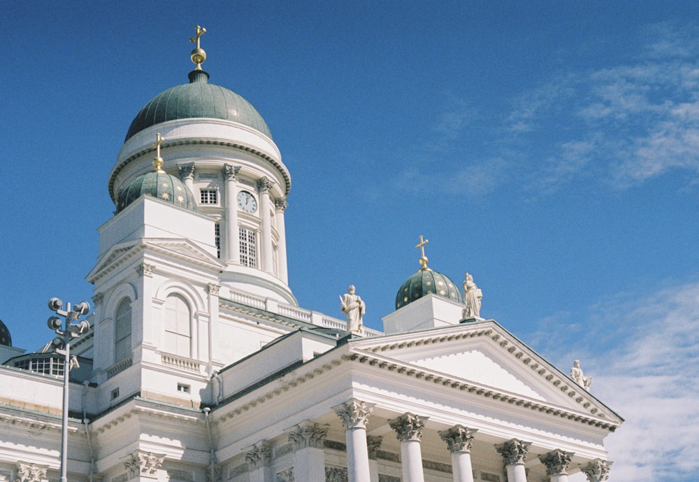 a large white building with a clock tower