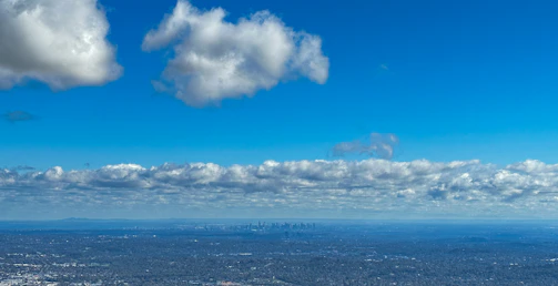 A panoramic view of a plot of land ready for development under clear blue skies.