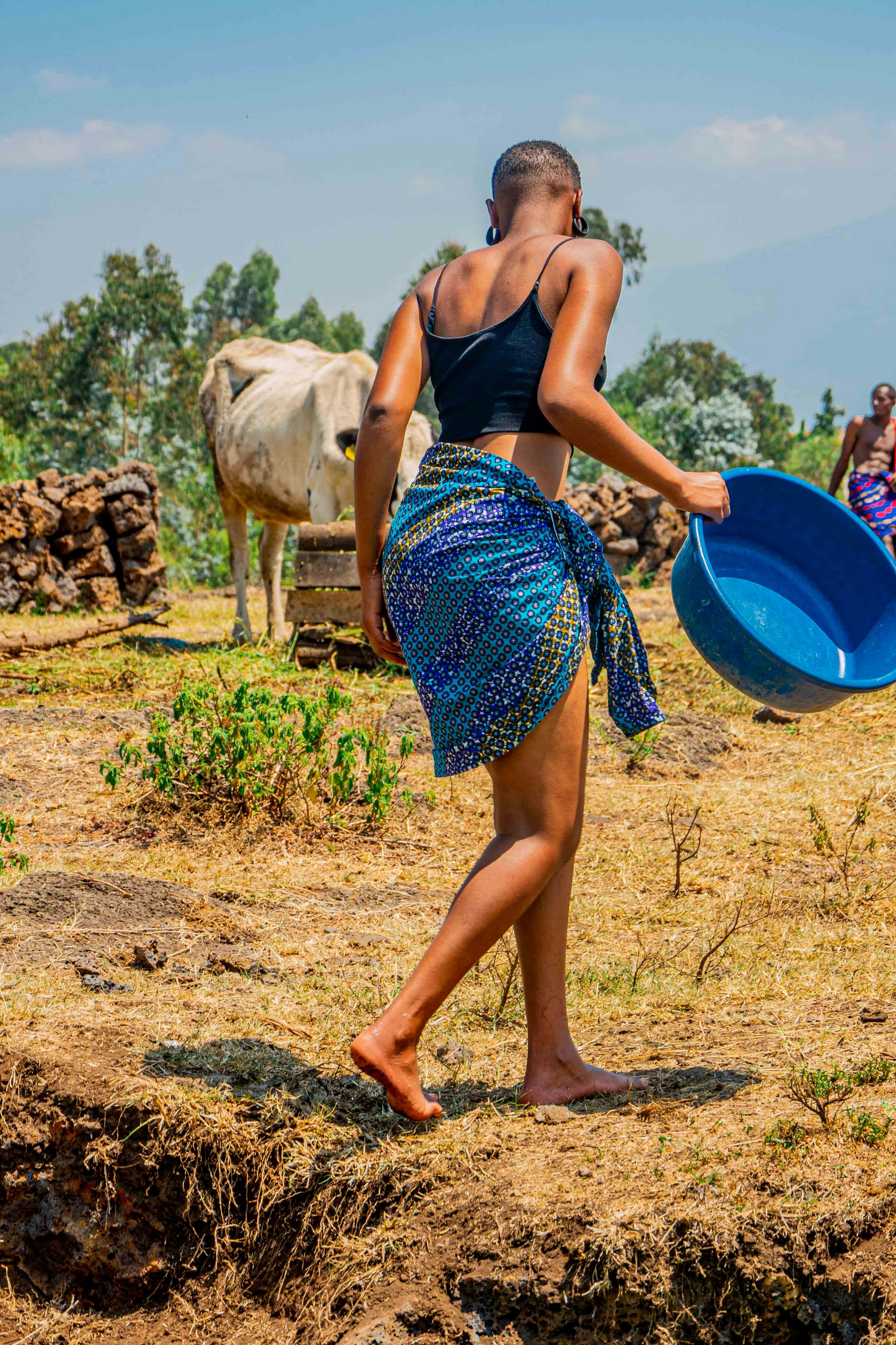 a woman in a blue skirt holding a blue frisbee
