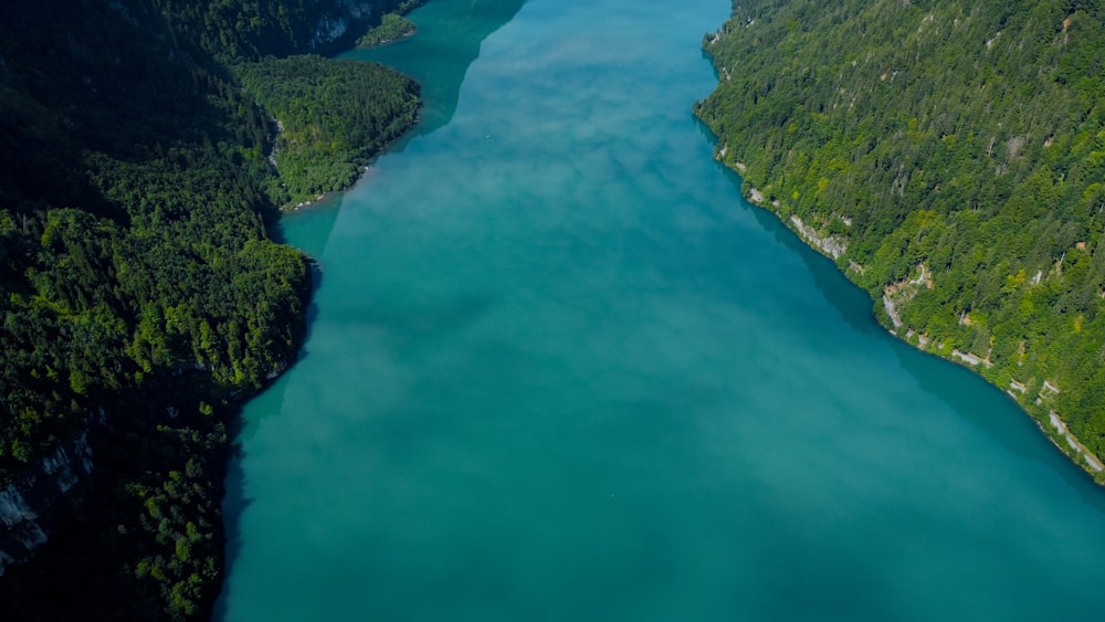 an aerial view of a body of water surrounded by mountains