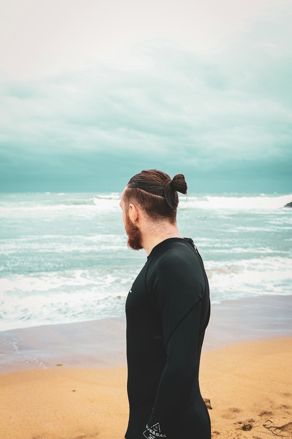 a person standing on a beach near the ocean