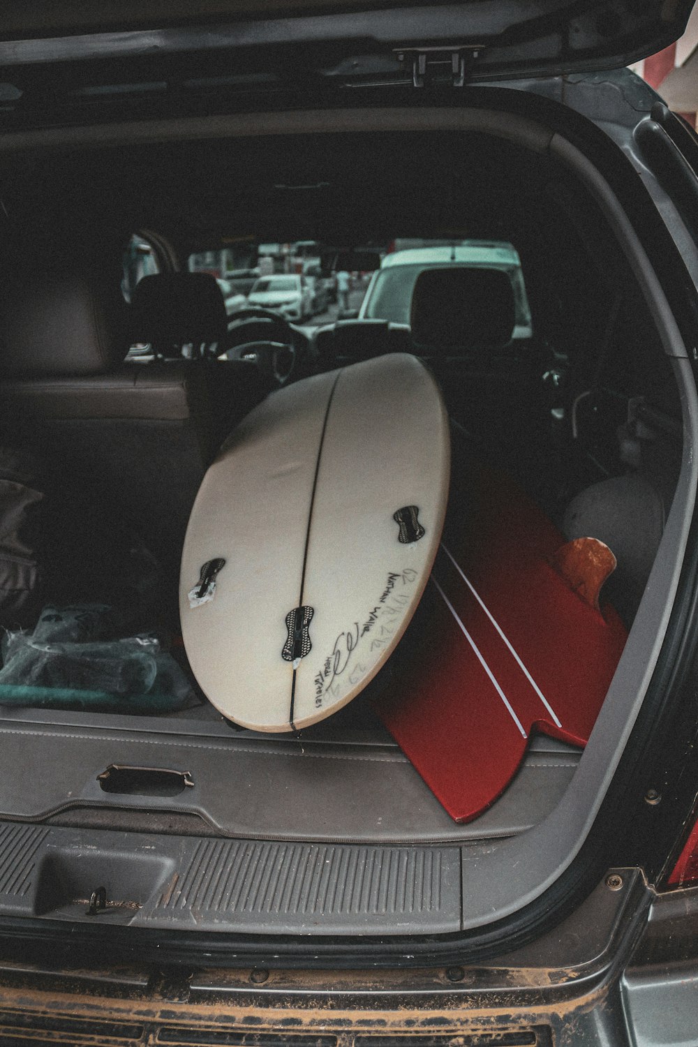 a surfboard sitting in the back of a car