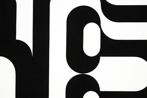 Large-scale canvas with bold geometric shapes contrasted against a neutral background.