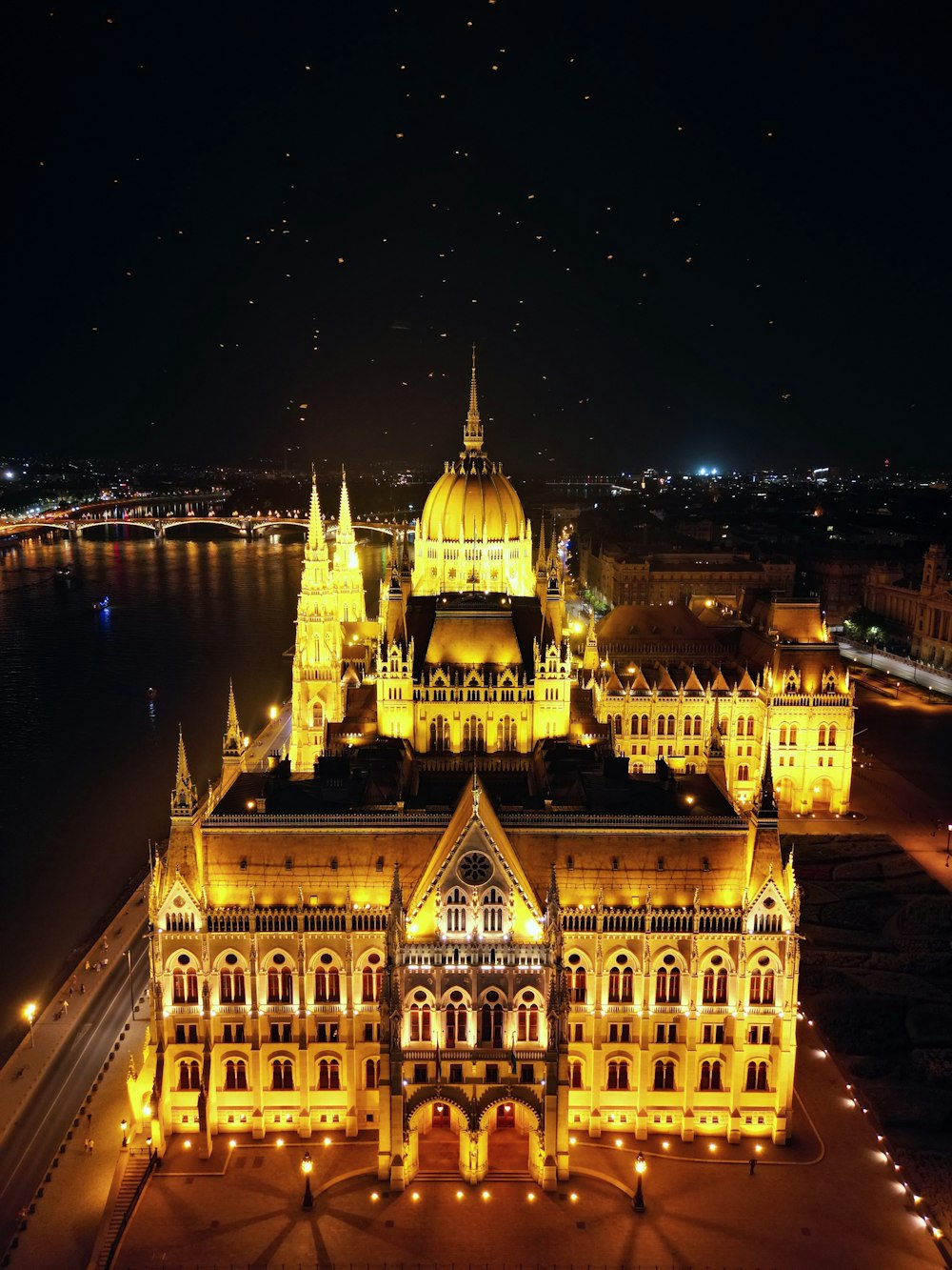 an aerial view of a building lit up at night