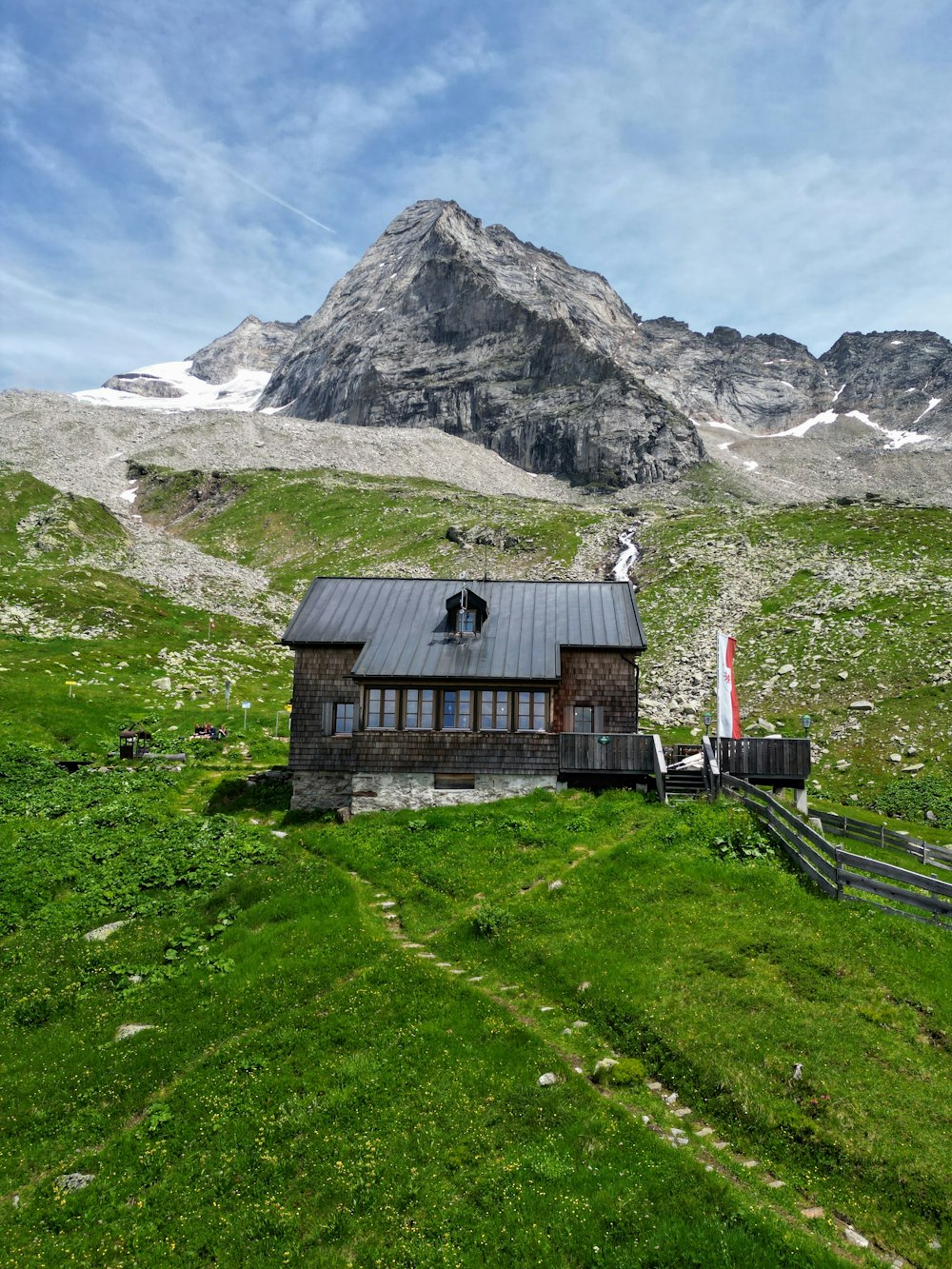 a house on a hill with a mountain in the background