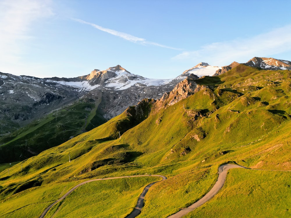 a road winding through a lush green valley