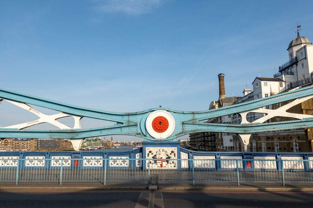 a blue and white bridge with a red circle on it