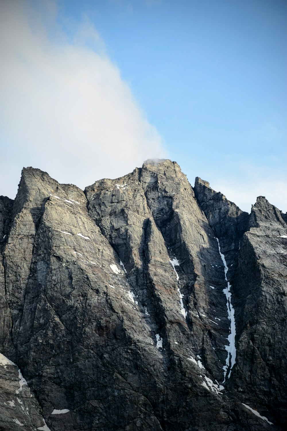 a very tall mountain with some snow on it