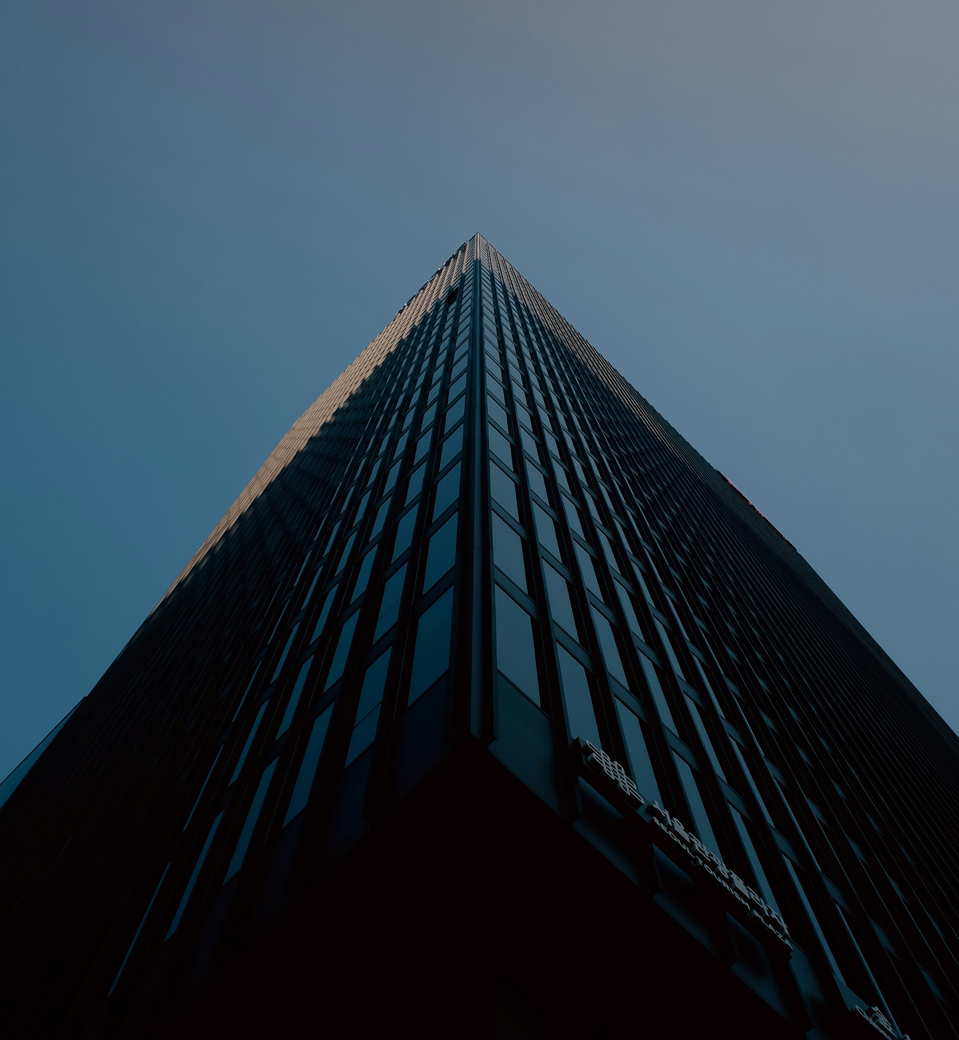 looking up at the top of a tall building