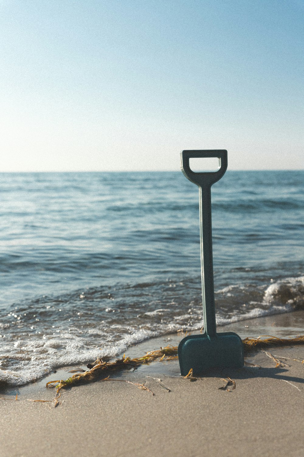 a metal object sitting on top of a sandy beach