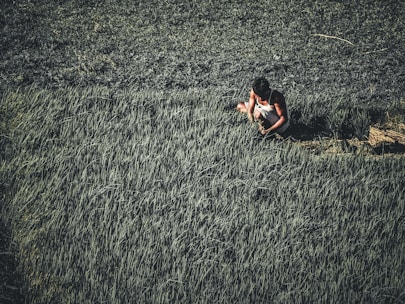A farmer working in a lush green field.