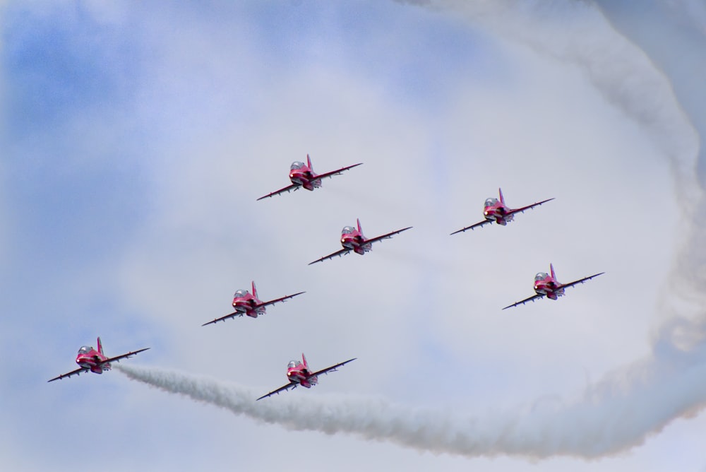 a group of planes flying in formation in the sky