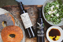 a table topped with a bagel and a bowl of salad